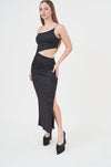 Elegant black maxi dress with side slit, creating a stylish and figure-flattering look.