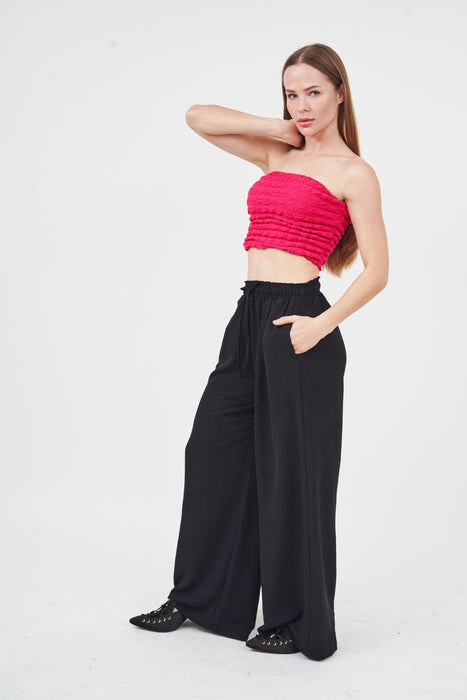 Stylish fuchsia crop top for trendy women on a white background