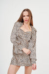 Trendy leopard print dress with ruched sleeves, featuring a fitted silhouette and puff sleeve design.