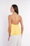 Elegant floral embroidered yellow halter top showing woman's back