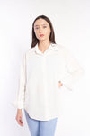 Oversized linen shirt in chic and cozy white, model showcasing comfortable fit.