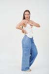 Flattering wide-leg denim jeans from H Apparel, featuring a stylish model in a white tank top.