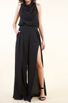 Elegant high-slit black jumpsuit with waist tie, showcased against a plain background.