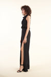 Elegant High-Slit Black Jumpsuit with Waist Tie on a female model with curly hair against a white background.