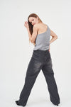 Stylish asymmetric women's vest top, comfortable chic gray tank, trendy high-waisted dark denim jeans, modern fashion-forward look.