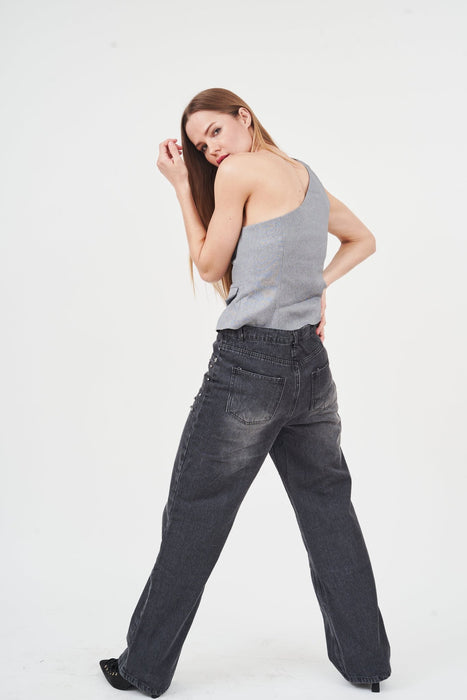 Stylish asymmetric women's vest top, comfortable chic gray tank, trendy high-waisted dark denim jeans, modern fashion-forward look.